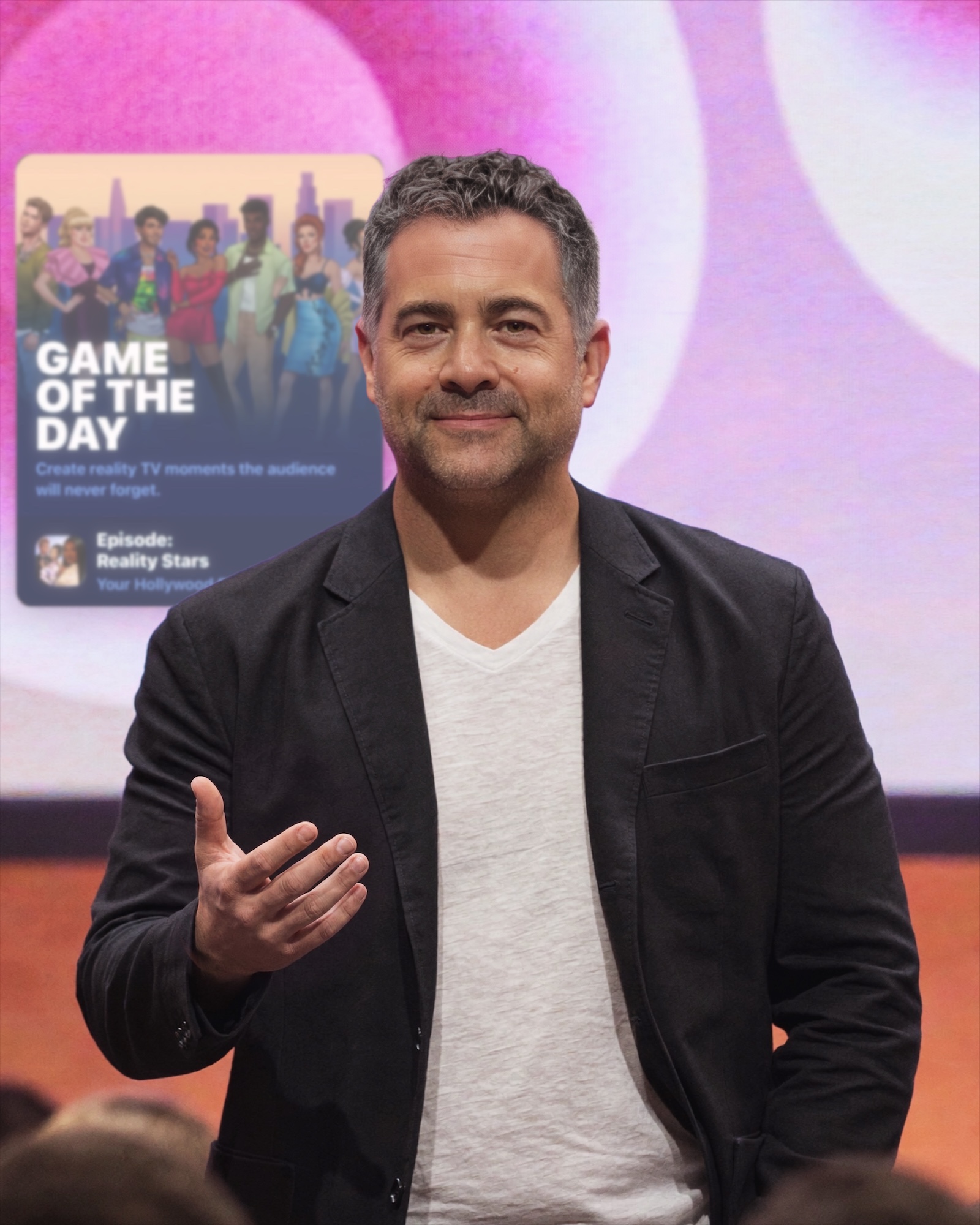AI render of Arthur as creative director on the Reality Stars keynote stage, the App Store Game of the Day card on the screen behind him
